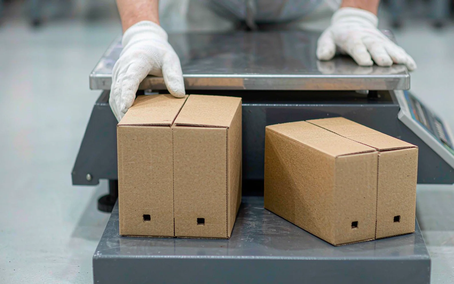 Cartons being weighed on a platform scale before shipment